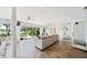Bright and airy sunroom boasts tile flooring, comfortable seating, and panoramic views of the lake at 8473 Granada Blvd, Orlando, FL 32836