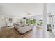 Bright living room with tile flooring, large windows overlooking the lush backyard, and stylish decor at 8473 Granada Blvd, Orlando, FL 32836