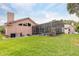 Expansive backyard featuring a screened-in pool area and well-maintained lawn at 8704 Ingleton Ct, Orlando, FL 32836