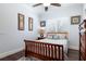A bedroom with a wooden bedframe, hardwood floors, and a ceiling fan at 8704 Ingleton Ct, Orlando, FL 32836