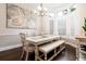 Charming dining area with a bright chandelier, white dining table, and bay window at 8704 Ingleton Ct, Orlando, FL 32836