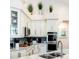 Well-lit kitchen with a corner sink, modern appliances, and ample counter space at 8704 Ingleton Ct, Orlando, FL 32836