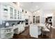 Eat-in kitchen featuring white cabinets, stainless appliances, and dark hardwood floors at 8704 Ingleton Ct, Orlando, FL 32836