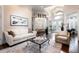 Bright living room with a large window, high ceiling, and stylish furnishings at 8704 Ingleton Ct, Orlando, FL 32836
