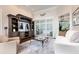 Well-lit living room featuring a entertainment center and sliding glass door at 8704 Ingleton Ct, Orlando, FL 32836