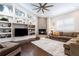 Open concept living room with fireplace, high ceilings, and hardwood floors at 8704 Ingleton Ct, Orlando, FL 32836