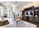 Spacious living room with large windows, a cozy fireplace, and hardwood flooring at 8704 Ingleton Ct, Orlando, FL 32836