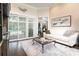 Bright living room featuring dark wood floors and sliding glass doors to the pool area at 8704 Ingleton Ct, Orlando, FL 32836
