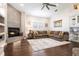 Comfortable living room featuring a cozy fireplace, hardwood floors, and a ceiling fan at 8704 Ingleton Ct, Orlando, FL 32836