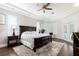 Tranquil main bedroom featuring hardwood floors, tray ceilings, and a serene ambiance at 8704 Ingleton Ct, Orlando, FL 32836