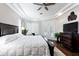 A main bedroom with a dark wood furnishings, white bedding, and access to the pool area at 8704 Ingleton Ct, Orlando, FL 32836