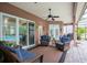 Inviting covered patio with comfortable seating and ceiling fan overlooking the pool area at 8704 Ingleton Ct, Orlando, FL 32836