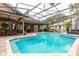 An in-ground pool enclosed by screen and lush landscaping at 8704 Ingleton Ct, Orlando, FL 32836