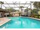 Spacious screened-in pool with lounge area, perfect for outdoor entertainment and relaxation at 8704 Ingleton Ct, Orlando, FL 32836