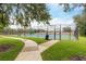 Community tennis court with well-maintained surface and surrounding greenery at 8704 Ingleton Ct, Orlando, FL 32836