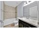 Bathroom featuring a combination bathtub and shower, tile backsplash, modern vanity and a tiled floor at 907 Pearly Ridge Ln, Lakeland, FL 33809