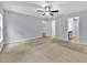 Spacious neutral bedroom with ceiling fan, ensuite bathroom, and closet at 907 Pearly Ridge Ln, Lakeland, FL 33809