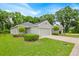 Charming single-story home with well-manicured lawn and two-car garage nestled among mature trees at 907 Pearly Ridge Ln, Lakeland, FL 33809