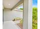 Covered front porch with white railing offers a shaded entry with a glimpse of lush greenery at 907 Pearly Ridge Ln, Lakeland, FL 33809