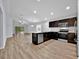 Modern kitchen flows into the living area, featuring stainless steel appliances and open concept design at 907 Pearly Ridge Ln, Lakeland, FL 33809