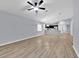 Open concept living space with hardwood floors, breakfast bar and view into the kitchen at 907 Pearly Ridge Ln, Lakeland, FL 33809