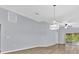 Open-concept living space featuring hardwood floors, modern lighting fixtures, and neutral wall colors at 907 Pearly Ridge Ln, Lakeland, FL 33809