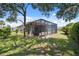 Enclosed lanai and backyard space with lush green lawn, perfect for outdoor relaxation and entertaining at 9426 Burnam Dr, Weeki Wachee, FL 34613