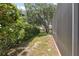 Backyard featuring a screen wall and lush greenery, offering privacy and a connection with nature at 9426 Burnam Dr, Weeki Wachee, FL 34613