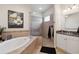 A modern bathroom featuring a soaking tub, glass enclosed shower, and neutral tiling at 9426 Burnam Dr, Weeki Wachee, FL 34613