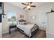 Comfortable bedroom with light walls, laminate floors, a ceiling fan, and natural lighting at 9426 Burnam Dr, Weeki Wachee, FL 34613