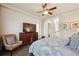 Comfortable bedroom with a ceiling fan, wood floors, a TV, and access to an ensuite bathroom at 9426 Burnam Dr, Weeki Wachee, FL 34613
