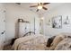 Cozy bedroom features a patterned bedspread, white armoire, and a ceiling fan for added comfort at 9426 Burnam Dr, Weeki Wachee, FL 34613