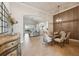 Open-concept dining area with a glass-top table, seating for six, and a view of the living area at 9426 Burnam Dr, Weeki Wachee, FL 34613