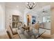 Elegant dining room featuring a glass table, modern chandelier, and stylish decor at 9426 Burnam Dr, Weeki Wachee, FL 34613