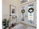 Inviting foyer with decorative glass double doors, a stylish console table, and neutral decor at 9426 Burnam Dr, Weeki Wachee, FL 34613