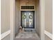 Elegant double front doors featuring glass panels and decorative wreaths, inviting entry to the home at 9426 Burnam Dr, Weeki Wachee, FL 34613