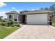 Charming single-story home with manicured landscaping, neutral paint, and an inviting double-door entrance at 9426 Burnam Dr, Weeki Wachee, FL 34613