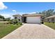 Charming single-story home with manicured landscaping, neutral paint, and an inviting double-door entrance at 9426 Burnam Dr, Weeki Wachee, FL 34613
