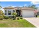 Charming single-story home with manicured landscaping, neutral paint, and an inviting double-door entrance at 9426 Burnam Dr, Weeki Wachee, FL 34613