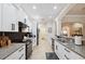 Kitchen features white cabinets, granite countertops, black appliances, and a modern backsplash at 9426 Burnam Dr, Weeki Wachee, FL 34613