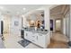 Kitchen with white cabinets, granite countertops, black appliances, and a view to the living area at 9426 Burnam Dr, Weeki Wachee, FL 34613