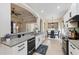 Bright kitchen with granite countertops, a view to the breakfast nook, and an open floor plan at 9426 Burnam Dr, Weeki Wachee, FL 34613
