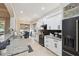 Bright kitchen featuring white cabinets, granite countertops, and stainless steel appliances at 9426 Burnam Dr, Weeki Wachee, FL 34613
