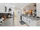 Kitchen featuring white cabinets, granite countertops, black appliances, and an open floor plan at 9426 Burnam Dr, Weeki Wachee, FL 34613