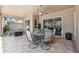 Covered lanai with comfortable seating, tile flooring, and views of the home's exterior at 9426 Burnam Dr, Weeki Wachee, FL 34613