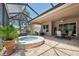 Spacious outdoor living area with a jacuzzi, patio seating, ceiling fan, and tile flooring at 9426 Burnam Dr, Weeki Wachee, FL 34613