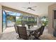Inviting screened-in lanai with a ceiling fan, table, chairs, and views of the yard at 9426 Burnam Dr, Weeki Wachee, FL 34613