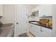 Laundry room featuring built-in cabinets, a utility sink, and a modern washer and dryer at 9426 Burnam Dr, Weeki Wachee, FL 34613
