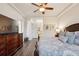 Main bedroom with wood floors, TV, decorative ceiling fan, and plenty of natural light at 9426 Burnam Dr, Weeki Wachee, FL 34613