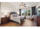Main bedroom featuring a decorative ceiling fan, wood floors, and plenty of natural light at 9426 Burnam Dr, Weeki Wachee, FL 34613